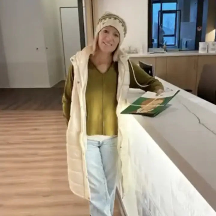Rachel Loeppky standing at reception desk, smiling at the camera